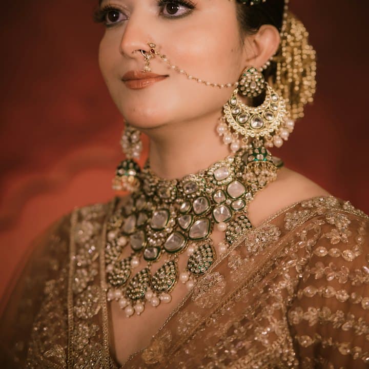 Woman wearing a traditional nose nath with gold jewellery